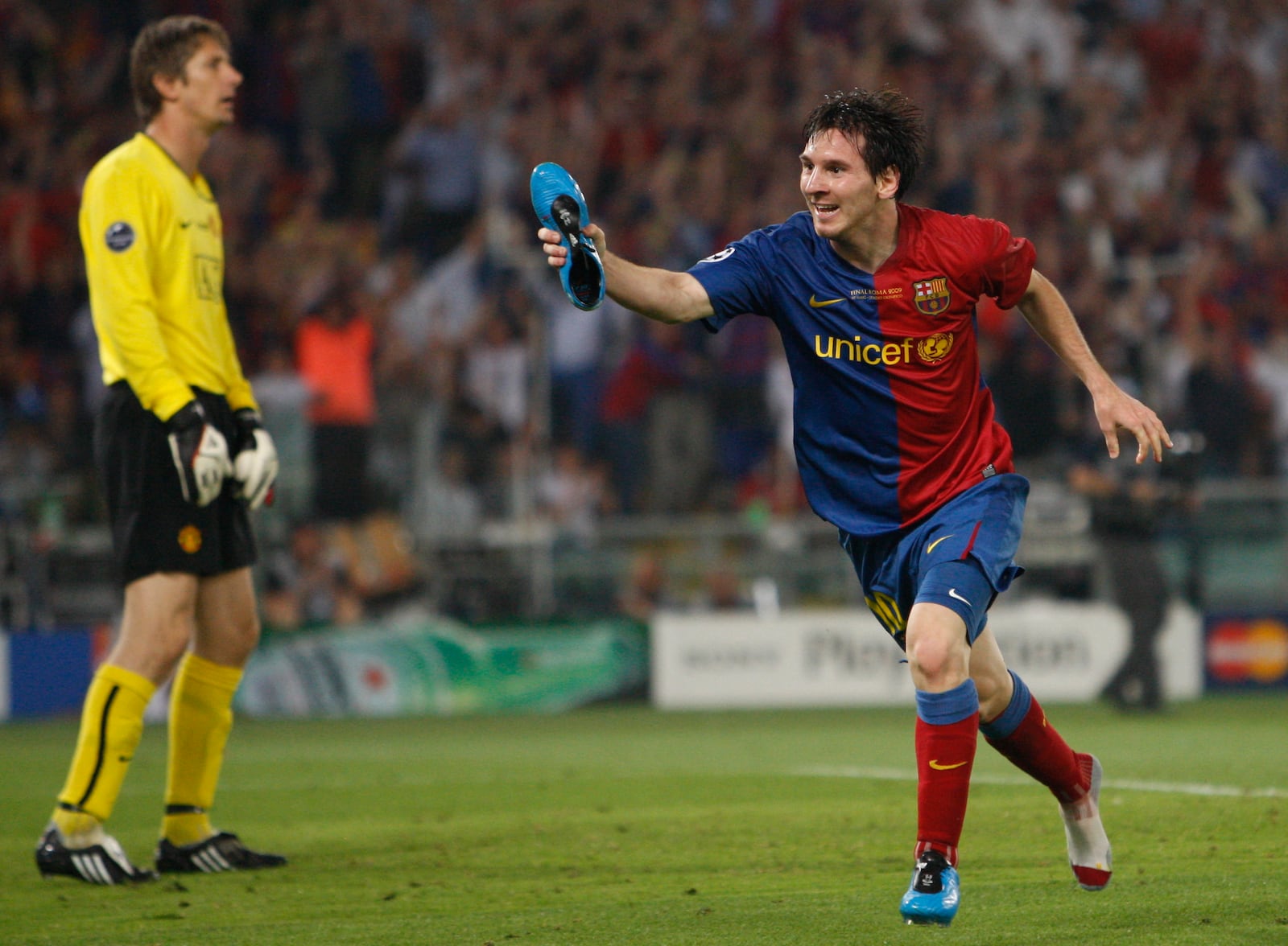 FILE - Barcelona's Lionel Messi shows his shoe as he reacts after scoring his side second goal, during the UEFA Champions League final soccer match between Manchester United and Barcelona in Rome, May 27, 2009. (AP Photo/Luca Bruno, File)