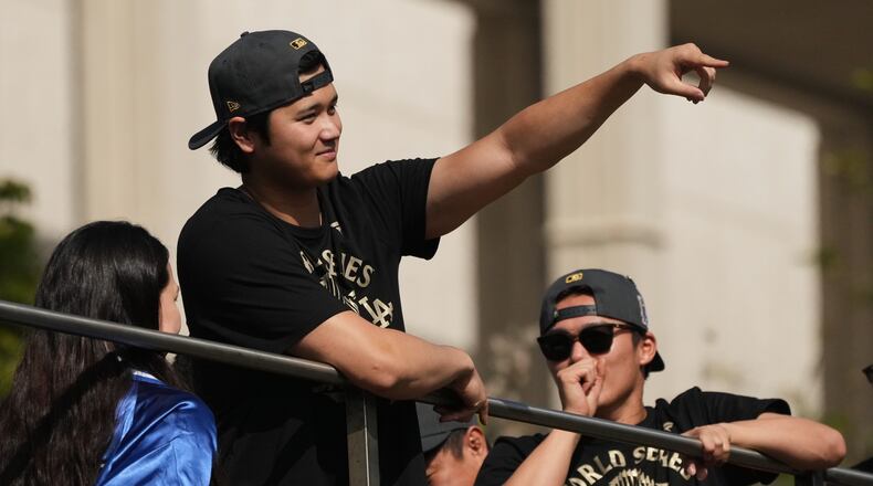 Los Angeles Dodgers' Shohei Ohtani points to fans during a parade to celebrate the baseball team's World Series win on Monday, Nov. 3, 2025, in Los Angeles. (AP Photo/Jae C. Hong)