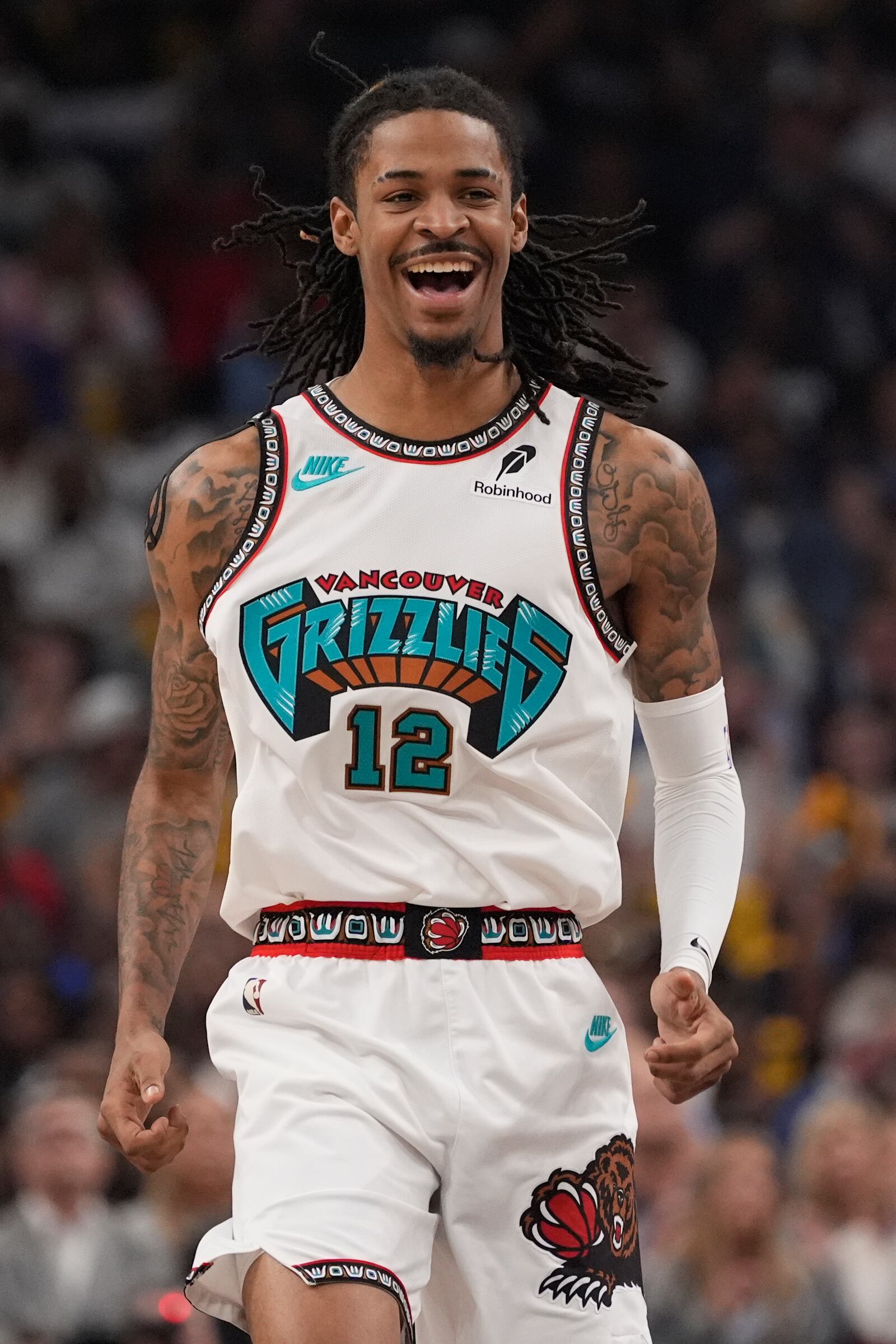Memphis Grizzlies guard Ja Morant (12) celebrates during the first half of an NBA play-in tournament basketball game against the Dallas Mavericks, Friday, April 18, 2025, in Memphis, Tenn. (AP Photo/George Walker IV)