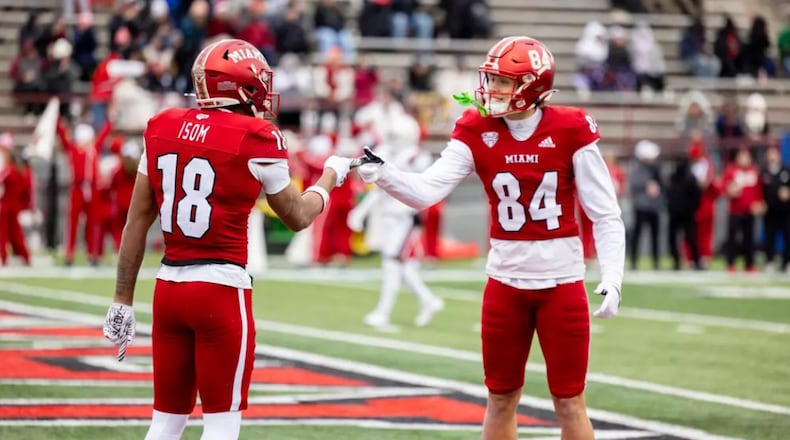 Miami's Braylon Isom (18) and Cole Weaver (84) celebrate after Isom caught a touchdown pass against Ball State on Saturday, Nov. 29, at Yager Stadium. JEFFREY SABO / MIAMI ATHLETICS