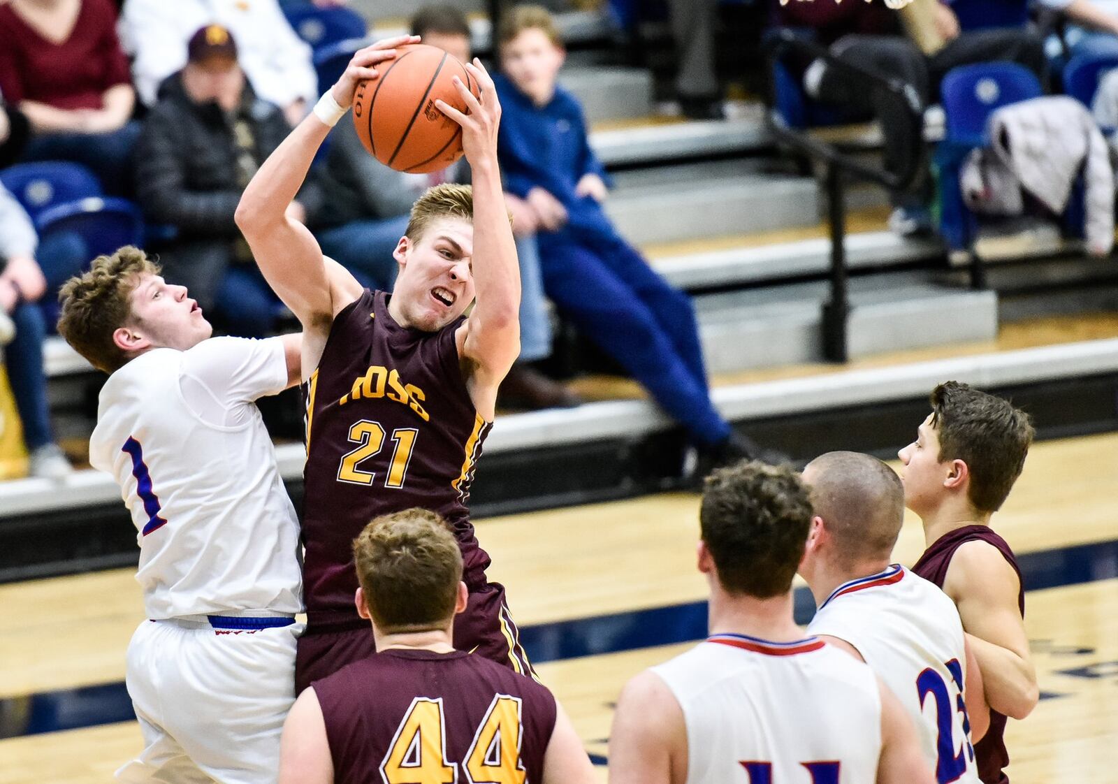 Landen Angel of Ross grabs a rebound over Clinton-Massie’s Daulton Wolfe during Friday’s Division II sectional game at Fairmont’s Trent Arena in Kettering. NICK GRAHAM/STAFF