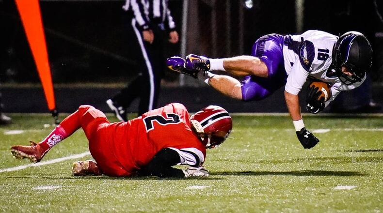 Madison’s Cameron Cooke (2) brings down Julian Herman of Cincinnati Hills Christian Academy during last Saturday’s Division V, Region 20 semifinal at Lakota East. NICK GRAHAM/STAFF