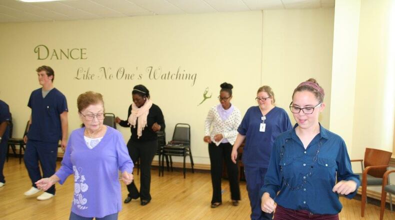Lakota West senior Kara Baumhardt and Lakota East seniors Jewell Pressley and Sena Omoruyi learn how to line dance with area seniors during a 3-day pilot program of a social work internship between Lakota School District and Community First Solutions.