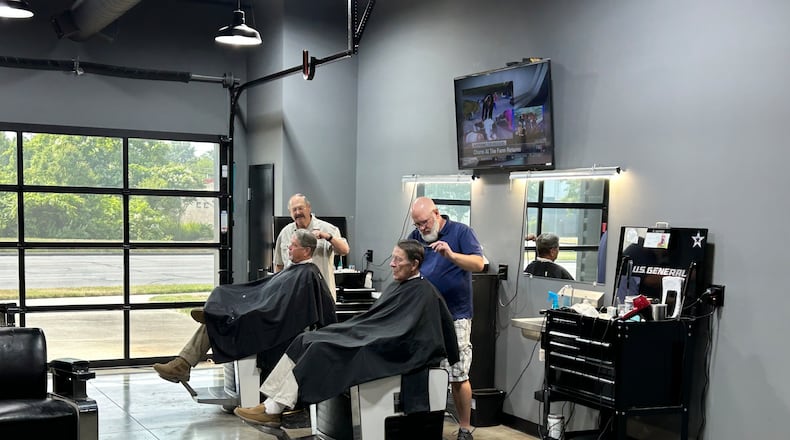 Hamilton West Barber Shop, 186 N. Brookwood Ave., was voted Butler County's best barber shop by Journal-News readers. The barber shop moved into a converted gas station/car wash four years ago and has seen plenty of changes over the years. Here, Steve Mallicote, 74, and Ryan Haynes, 48, the owner, cut hair while talking to their customers. RICK McCRABB/STAFF