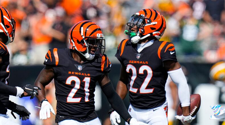 Cincinnati Bengals cornerback Chidobe Awuzie (22) celebrates an interception with Mike Hilton (21) in the first half of an NFL football game against the Green Bay Packers in Cincinnati, Sunday, Oct. 10, 2021. (AP Photo/AJ Mast)