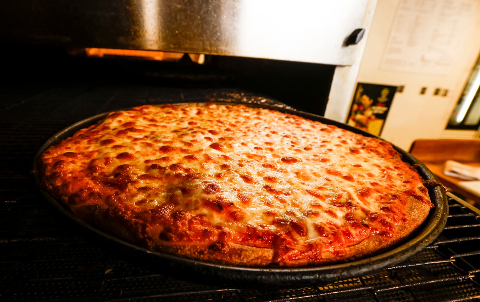 Chuck Vitale prepares a pizza order at Chester's Pizzeria on Dixie Highway in Hamilton Wednesday, June 21, 2023. NICK GRAHAM/STAFF 