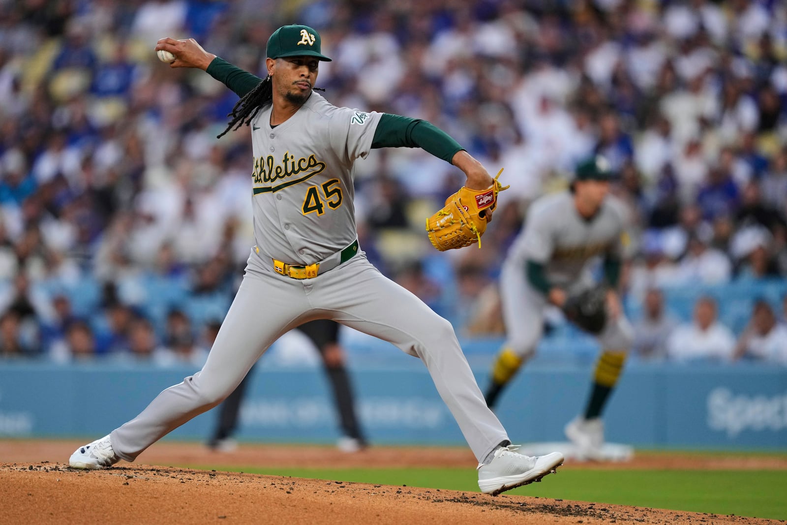 Athletics pitcher Osvaldo Bido throws to a Los Angeles Dodgers batter during the first inning of a baseball game Thursday, May 15, 2025, in Los Angeles. (AP Photo/Mark J. Terrill)