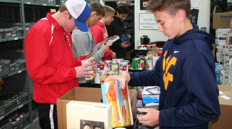 Lakota students help sort donated food at Reach Out Lakota as part of the community group’s annual food drive. Reach Out Lakota’s annual food drive — dubbed “Stuff The Bus” this year — saw a jump of 33 percent in donations. The food drive raised over 27,000 pounds this year, up from approximately 18,000 in 2016. CONTRIBUTED