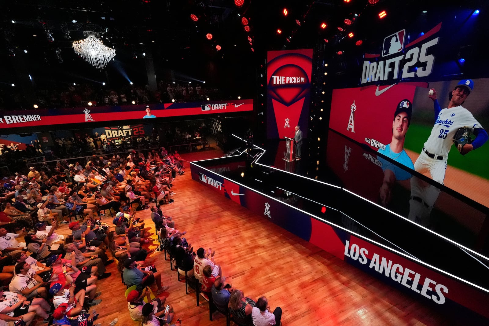 Fans gather to watch the first round of the MLB baseball draft Sunday, July, 13, 2025 in Atlanta. (AP Photo/Mike Stewart)