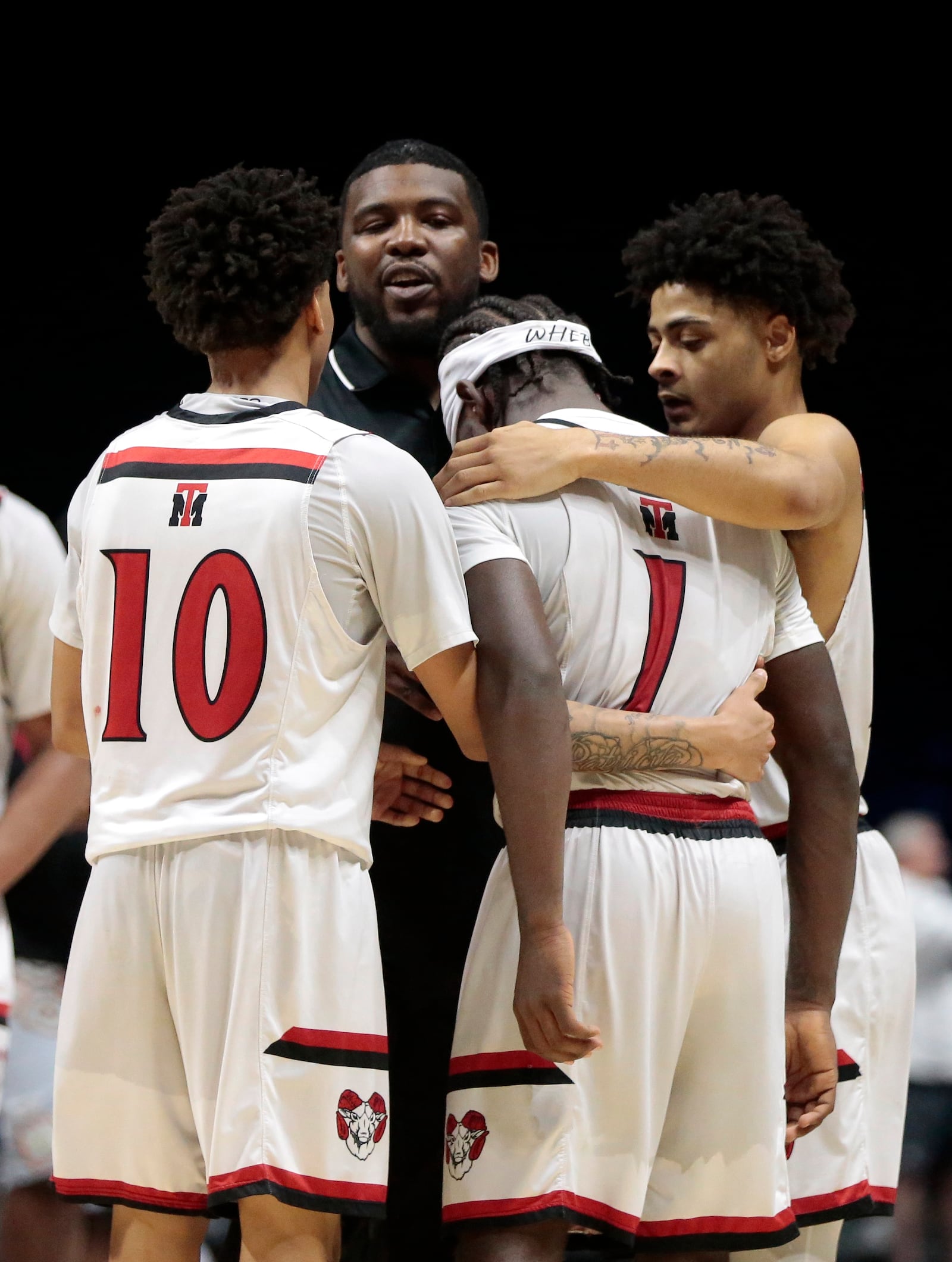 Trotwood players and coaches check on senior Je'Carious Reaves after a Division III regional semifinal game Tuesday, March 10, 2026, at the Cintas Center in Cincinnati. Trotwood won 46-44. STEVEN WRIGHT / STAFF