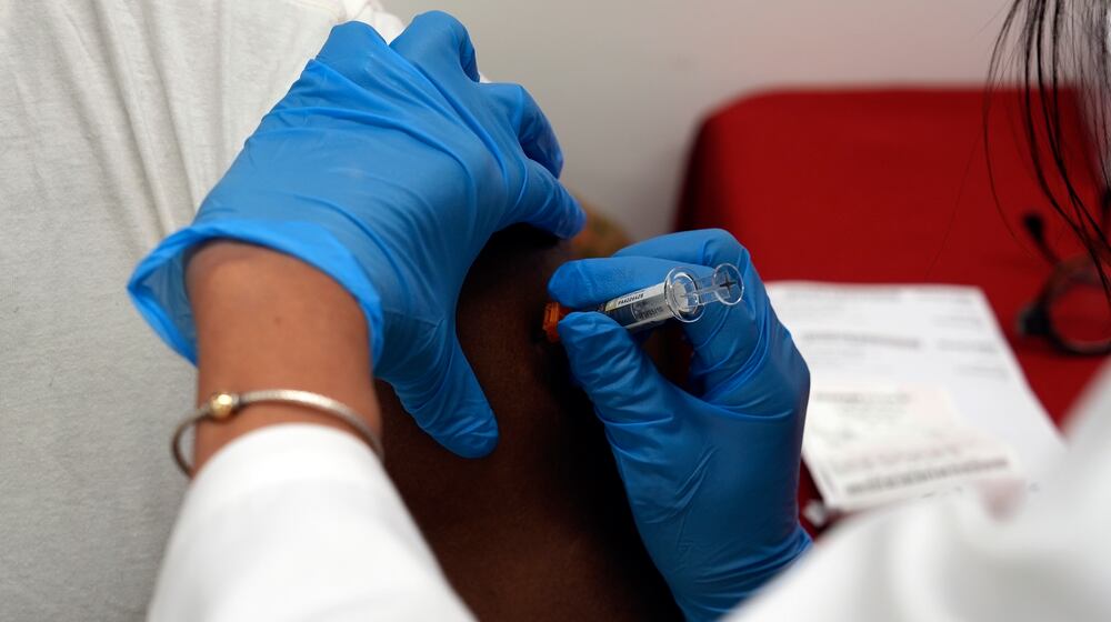 A pharmacist administers a COVID-19 vaccine at a pharmacy in New York, on Tuesday, Sept. 24, 2024. (AP Photo/Mary Conlon)