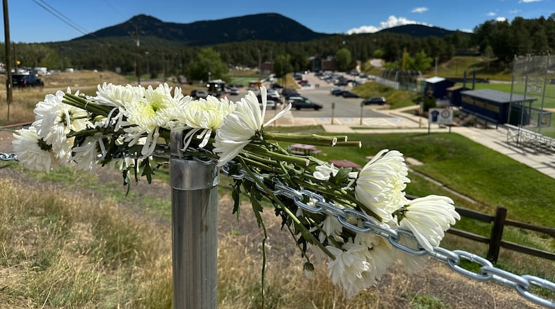 FILE - Flowers are left in remembrance of those wounded in a shooting at Evergreen High School in Evergreen, Colo., Thursday, Sept. 11, 2025. (AP Photo/Colleen Slevin, File)