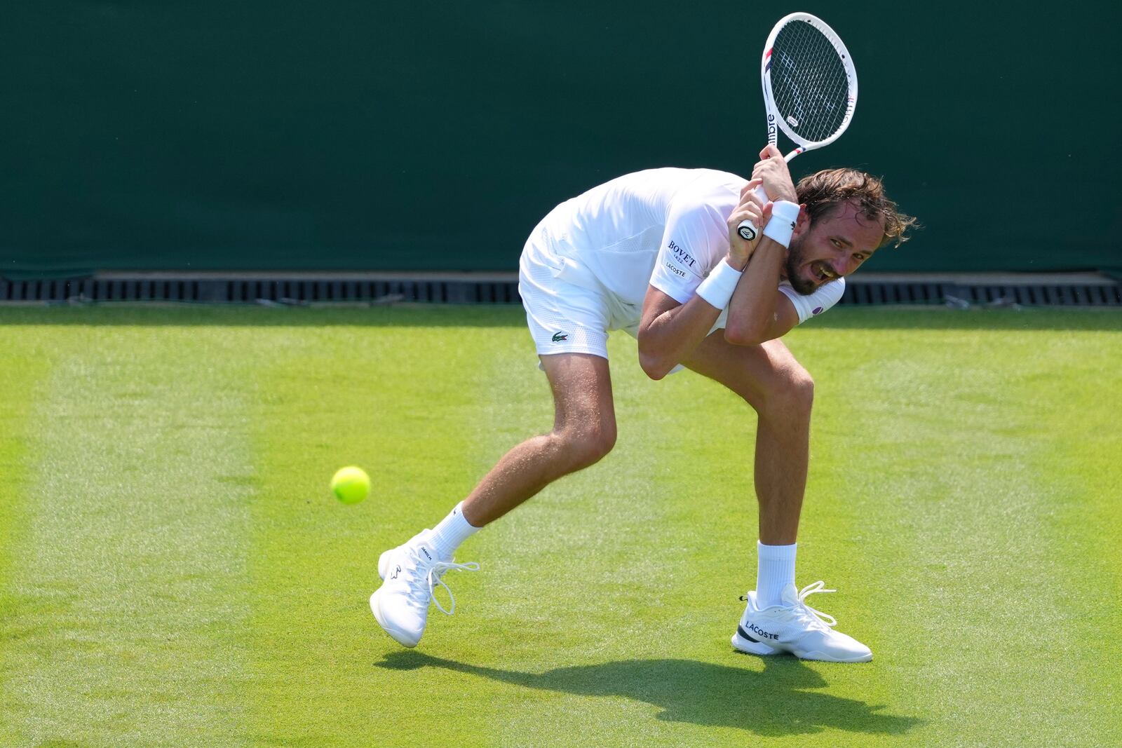 Daniil Medvedev of Russia returns the ball to Benjamin Bonzi of France during their first round men's single match at the Wimbledon Tennis Championships in London, Monday, June 30, 2025. (AP Photo/Kirsty Wigglesworth)