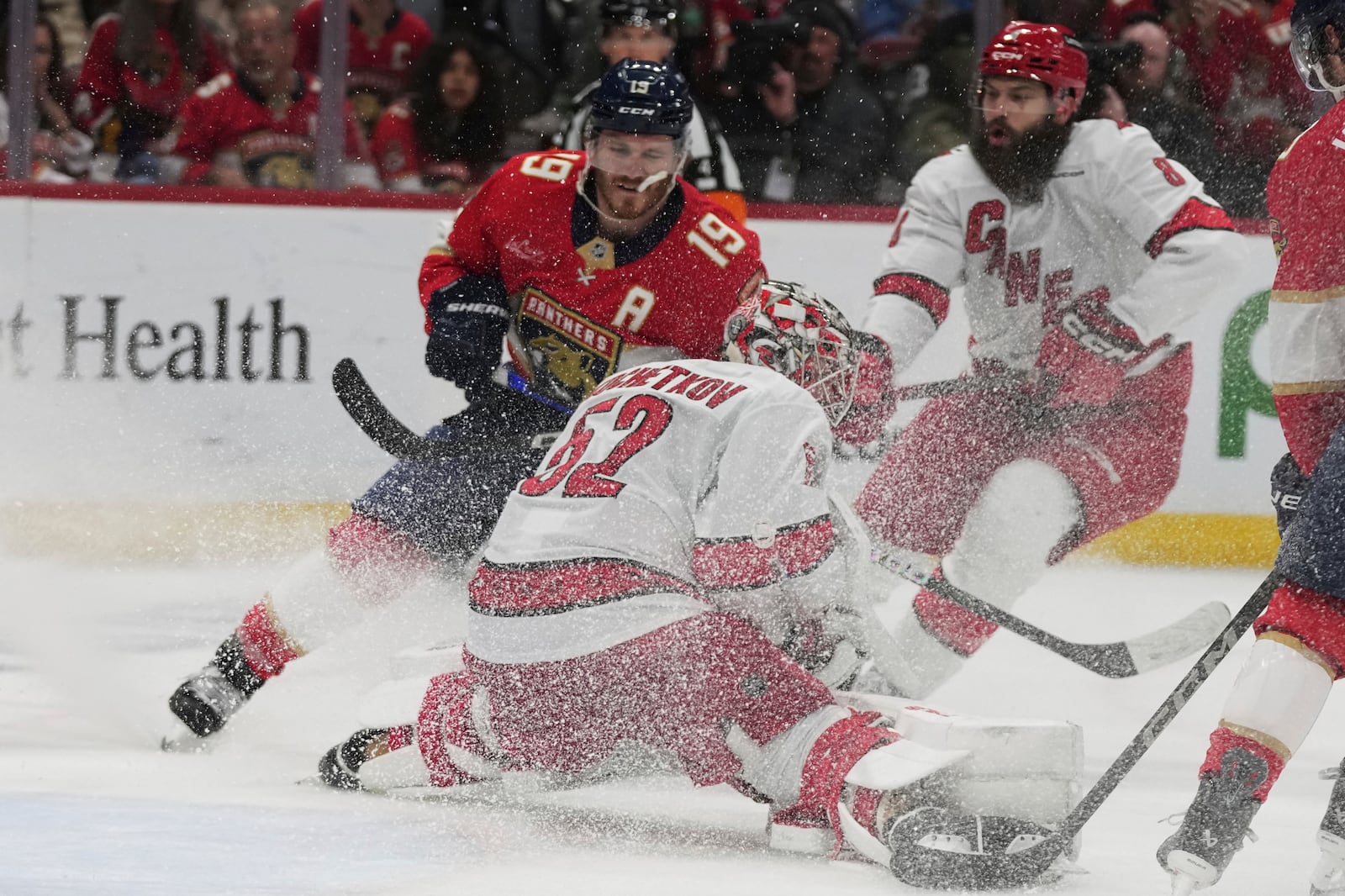 Carolina Hurricanes goaltender Pyotr Kochetkov (52) defends the goal against Florida Panthers left wing Matthew Tkachuk (19) during the second period in Game 3 of the NHL hockey Stanley Cup Eastern Conference finals Saturday, May 24, 2025, in Sunrise, Fla. (AP Photo/Lynne Sladky)