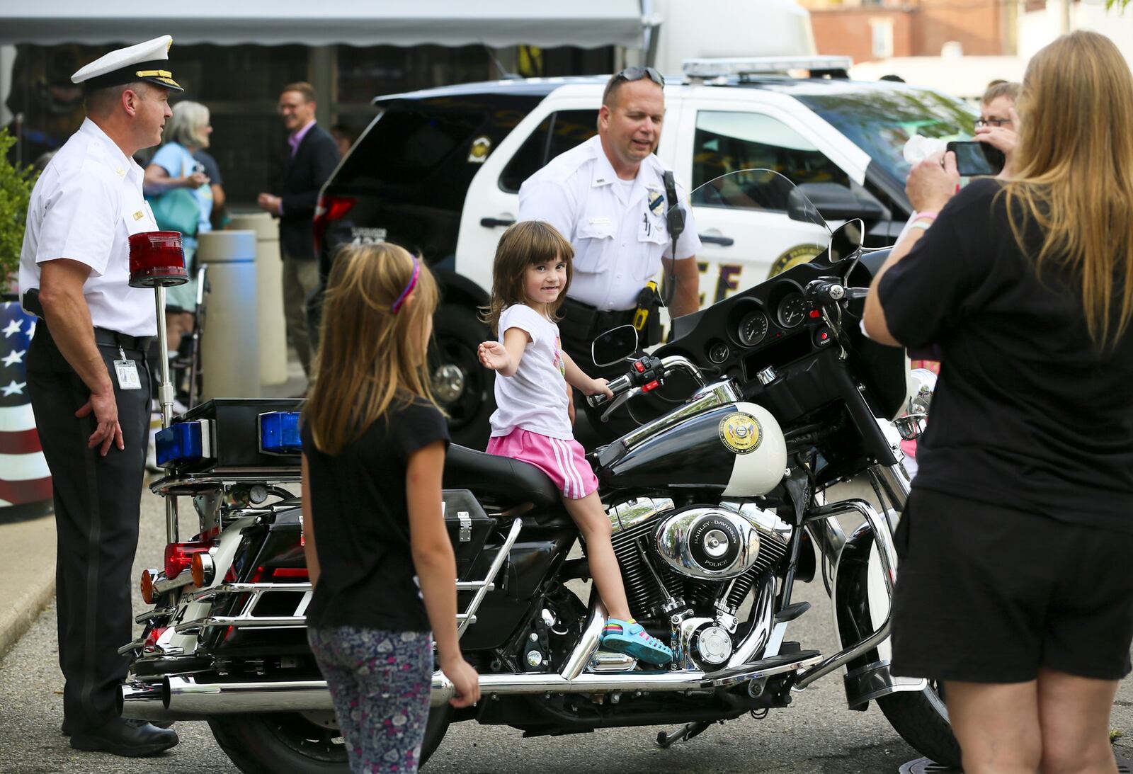 Kaydence McKinney, 9, and sister Hayden, 4, try out a Hamilton Police motorcycle during a previous National Night Out event. 