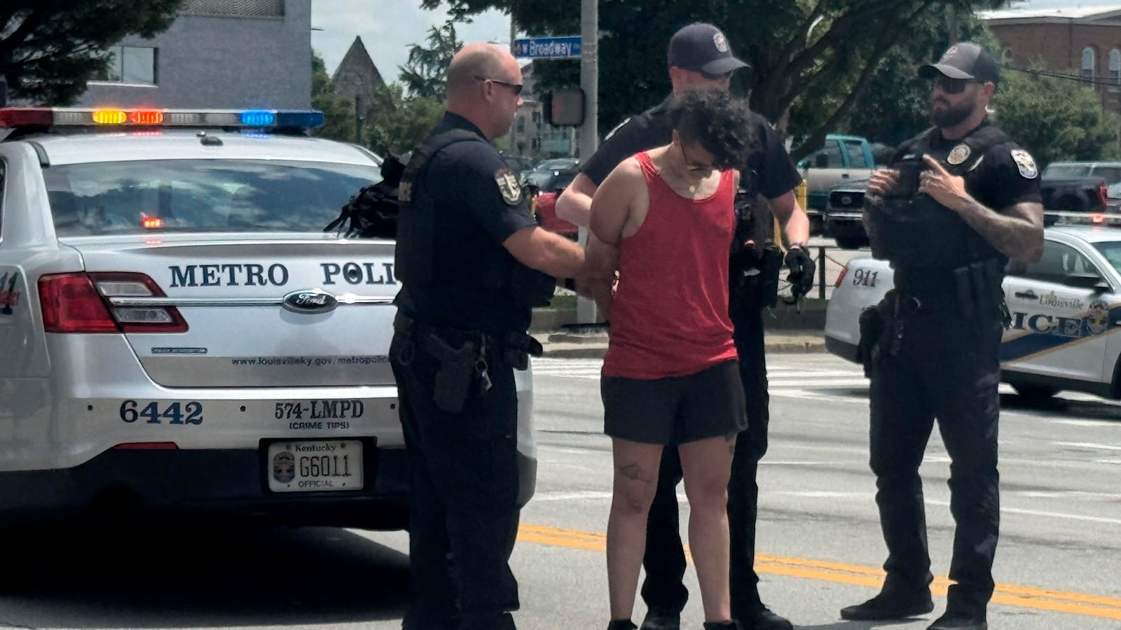 In this photo provided by WHAS-11 News, a protestor is seen detained by police outside the federal courthouse where ex-Kentucky police officer Brett Hankison, convicted of using excessive force during the deadly Breonna Taylor raid, is taking place, Monday, July 21, 2025, in Louisville, Ky. (Alyssa Newton/WHAS-11 News via AP)