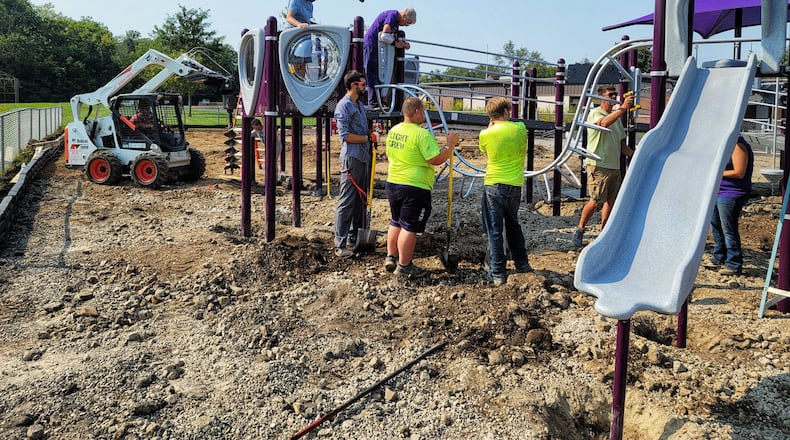 The playground at Amanda Elementary School on Oxford-State Road nears completion on Monday after four days of work from Middletown Kiwanis members and community volunteers. NICK GRAHAM/STAFF