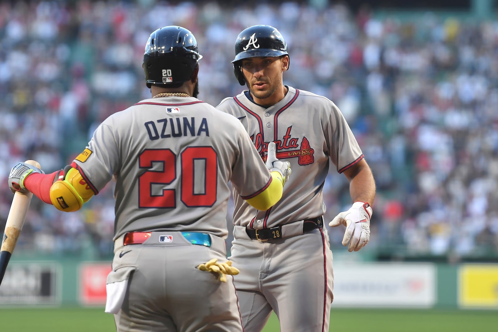 Atlanta Braves' Matt Olson, right, celebrates with Marcell Ozuna, left, after scoring on his two-run home run in the first inning of a baseball game against the Boston Red Sox, Saturday, May 17, 2025, in Boston. (AP Photo/Steven Senne)