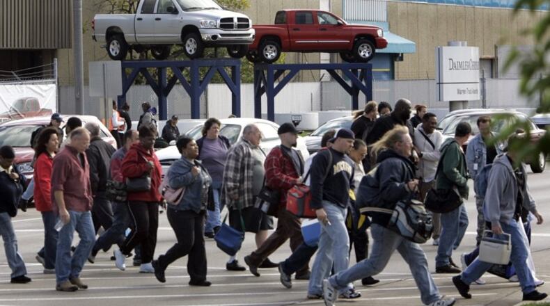 FILE - In an Oct. 24, 2007 file photo, workers leave the Warren Truck Assembly, a Chrysler automobile factory, during a shift change in Warren, Mich. Fiat Chrysler said Sunday, Jan. 8. 2017, it will add three new Jeeps to its lineup including a pickup truck as it invests $1 billion in two U.S. factories and creates 2,000 new jobs. (AP Photo/Carlos Osorio, File)