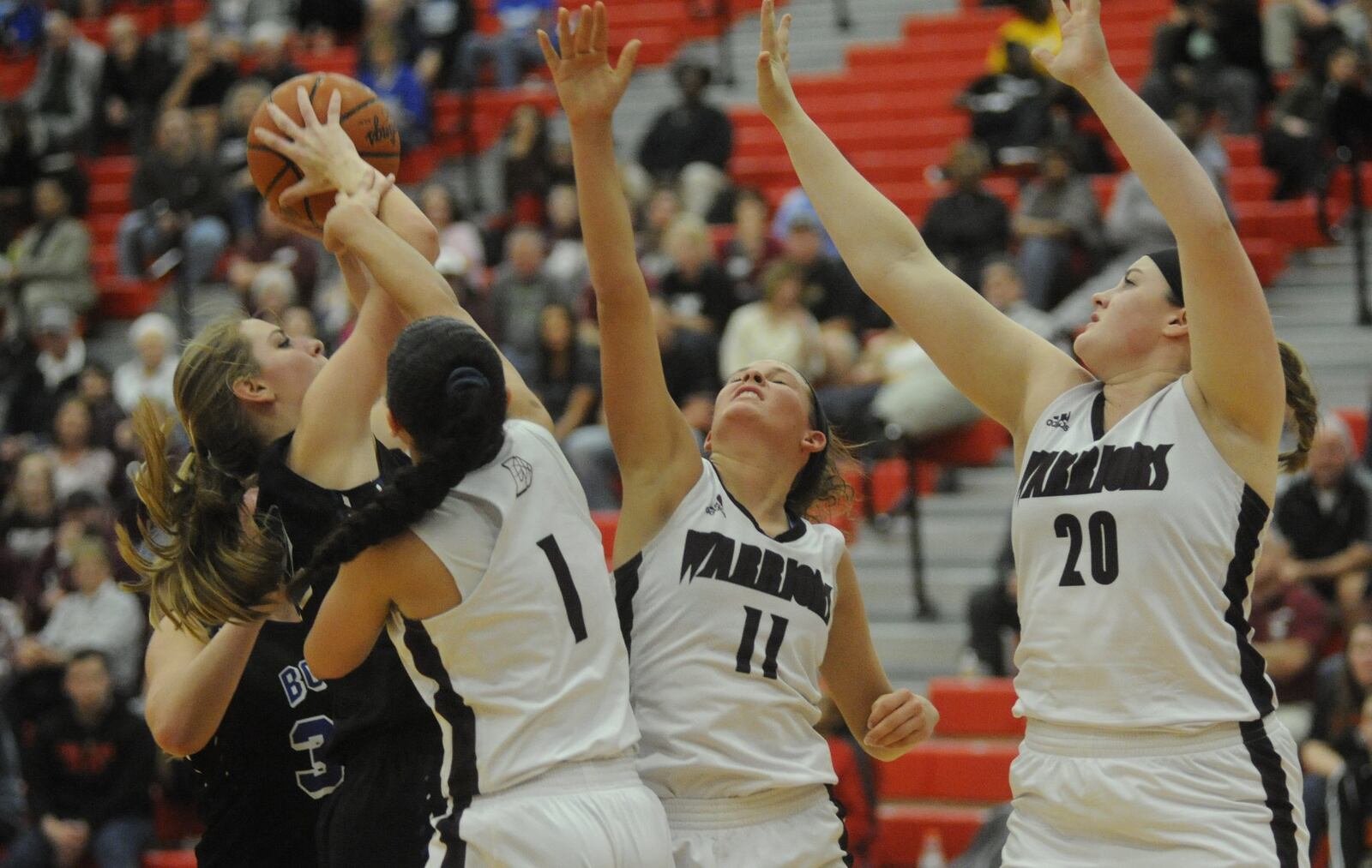 Springboro’s Lauren Thomas (with ball) draws Lebanon defenders Alexis Straw (1), Ashley West (11) and Cassidy Osborne during a Division I sectional final at Troy on Feb. 24, 2017. MARC PENDLETON/STAFF