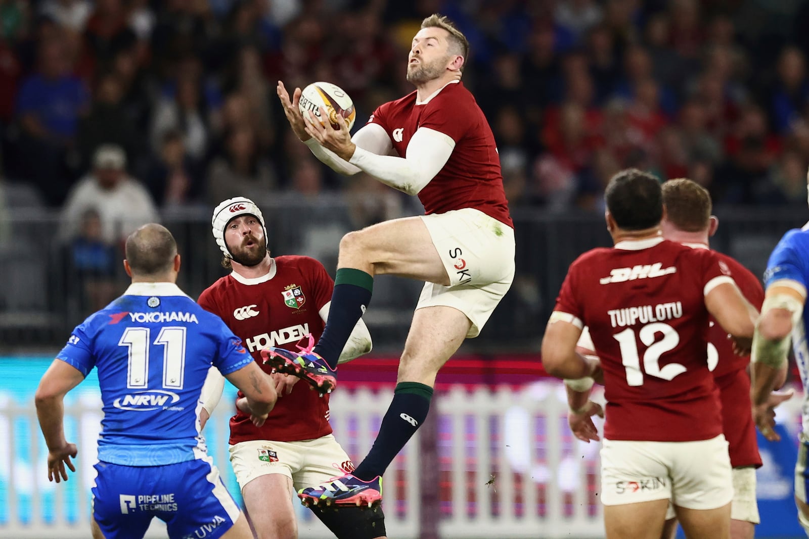 Elliot Daly of the British & Irish Lions leaps in the air to catch the ball during their rugby match against the Western Force in Perth, Australia, Saturday, June 28, 2025. (AP Photo/Trevor Collens)