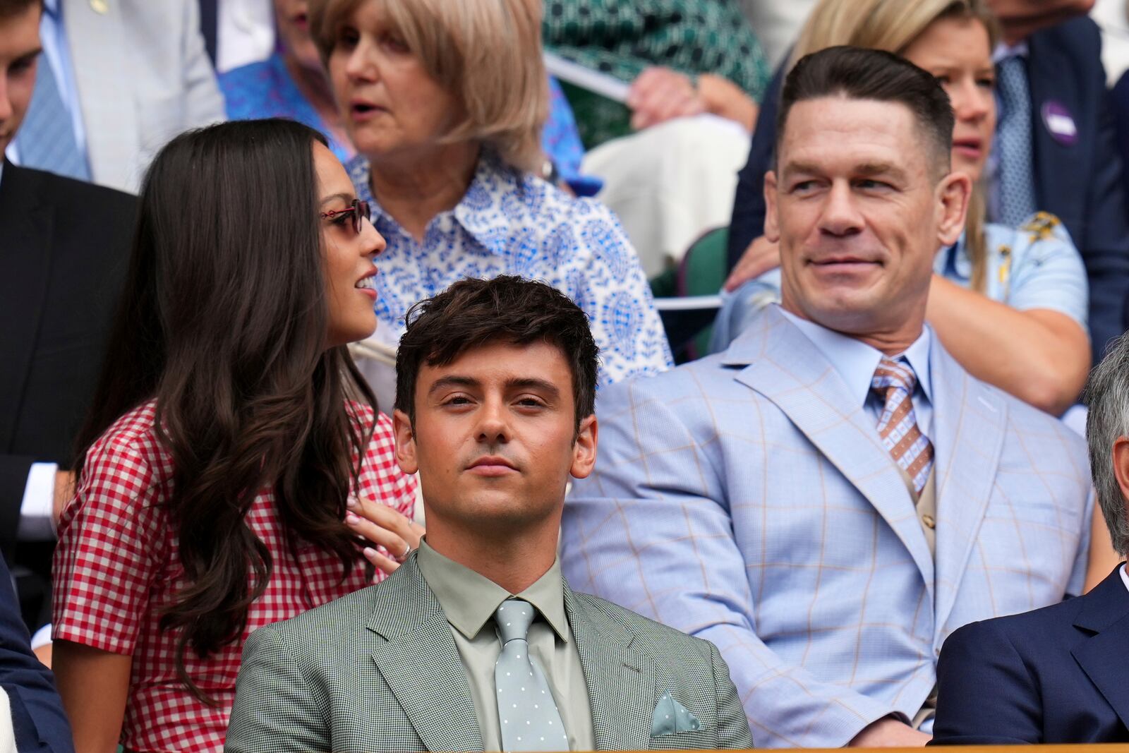 Olympic gold medallist Tom Daley, center, and wrestler John Cena sit in the Royal Box at Centre Court during the Wimbledon Tennis Championships in London, Wednesday, July 2, 2025.(AP Photo/Kirsty Wigglesworth)