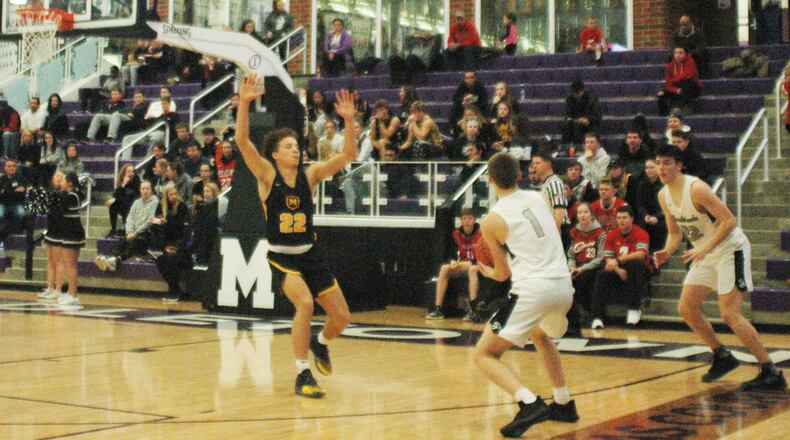 Moeller’s Max Land (22) brings some defensive pressure to Lakota East’s Nick Holtman (1) and Bash Wieland (22) during Sunday night’s Midwest King Classic contest at Middletown’s Wade E. Miller Arena. Moeller won 61-53. RICK CASSANO/STAFF