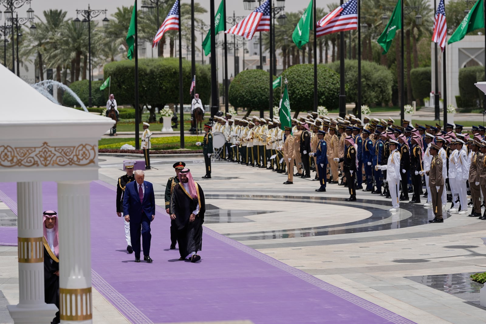 President Donald Trump and Saudi Crown Prince Mohammed bin Salman walk during an arrival ceremony at the Royal Palace in Riyadh, Saudi Arabia, Tuesday, May 13, 2025. (AP Photo/Alex Brandon)