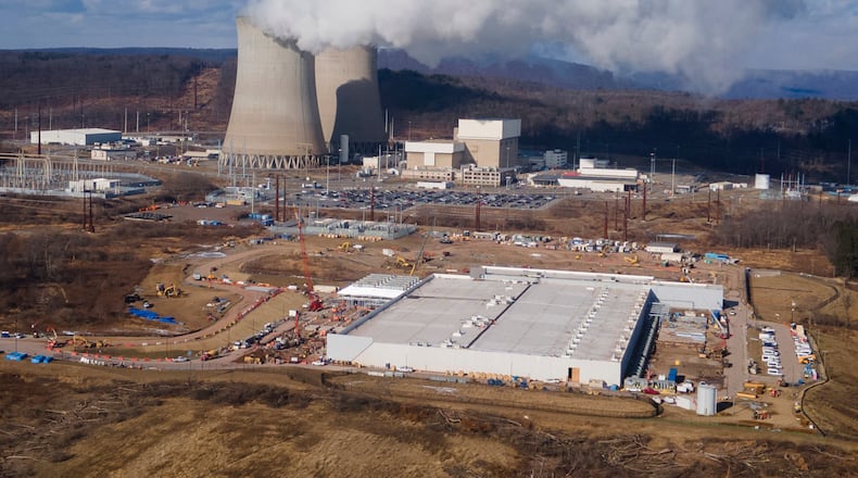 FILE - A data center owned by Amazon Web Services, front right, is under construction next to the Susquehanna nuclear power plant in Berwick, Pa., Jan. 14, 2025. (AP Photo/Ted Shaffrey, File)