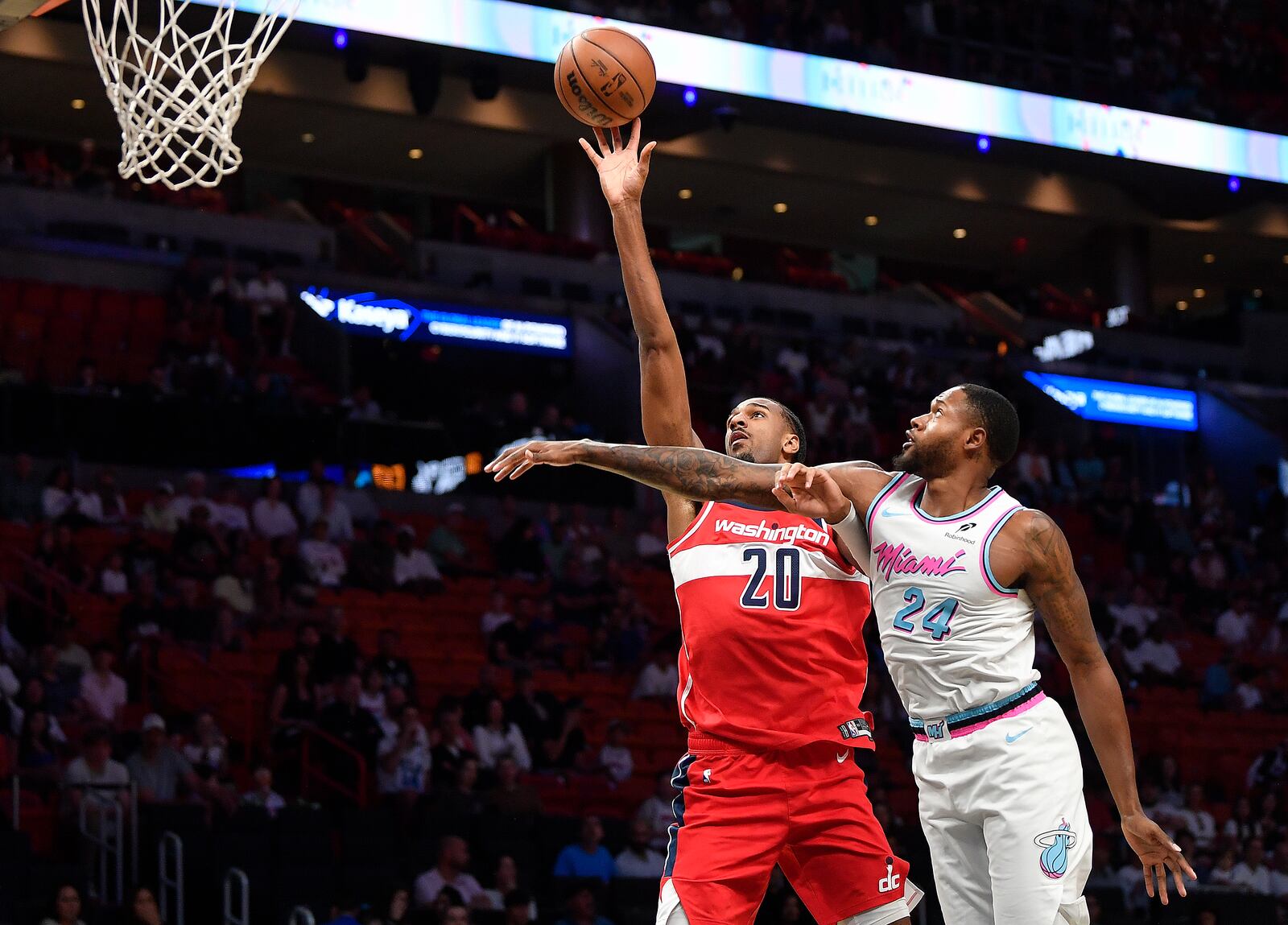 Washington Wizards forward Alex Sarr (20) shoots over Miami Heat forward Haywood Highsmith (24) during the first half of a basketball game, Sunday, April 13, 2025, in Miami. (AP Photo/Michael Laughlin)