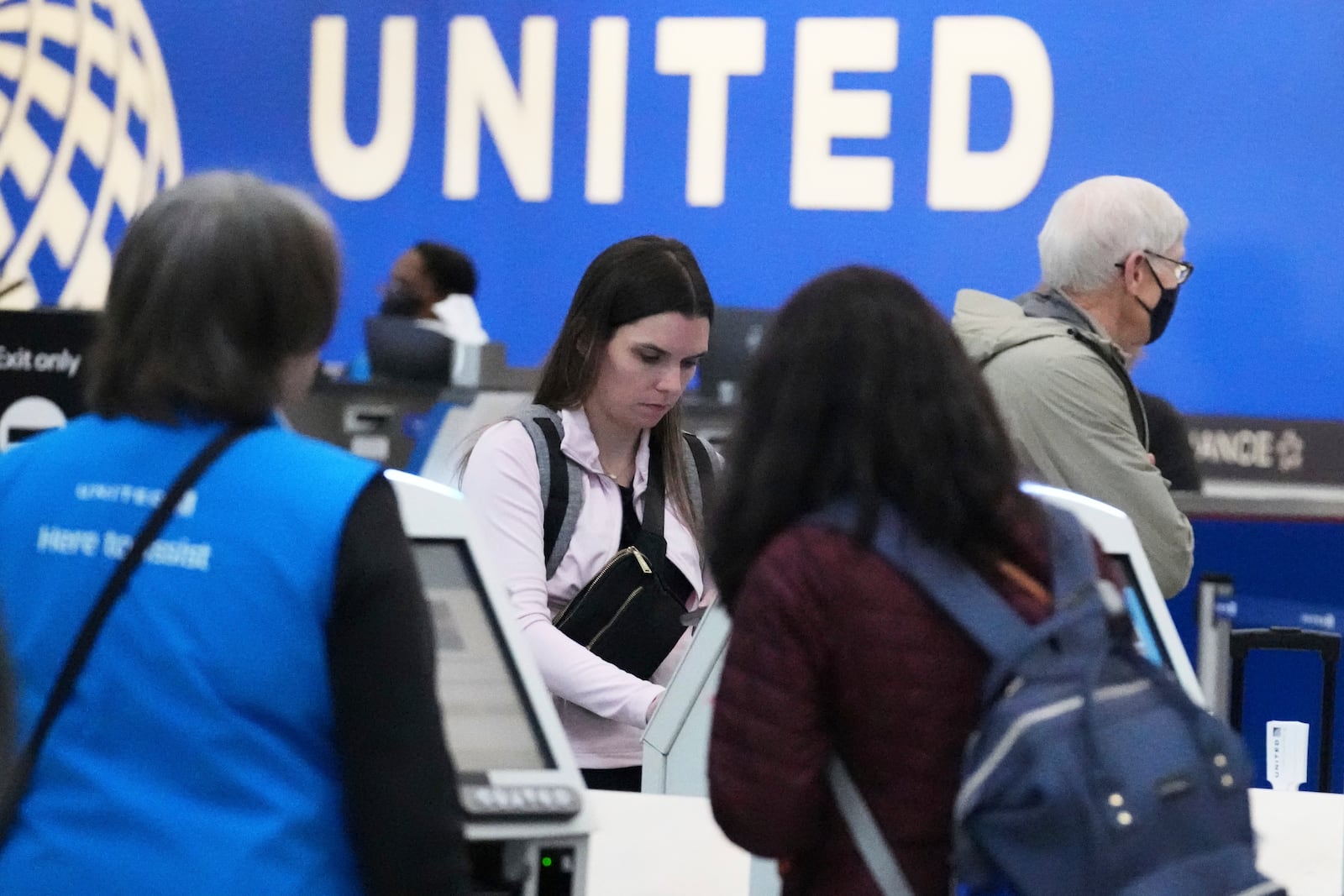 Travelers print their boarding passes at kiosks inside of O'Hare International Airport in Chicago, Friday, May 23, 2025. (AP Photo/Nam Y. Huh)