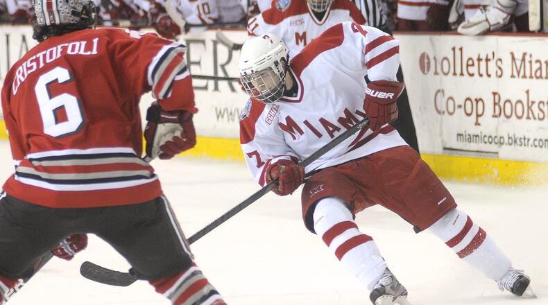 Miami Redhawks Austin Czarnik changes direction as his encounters Ohio State's Clark Cristofoli near the goal during their game Saturday, Mar. 2, 2013 at the Goggin Ice Center in Oxford.