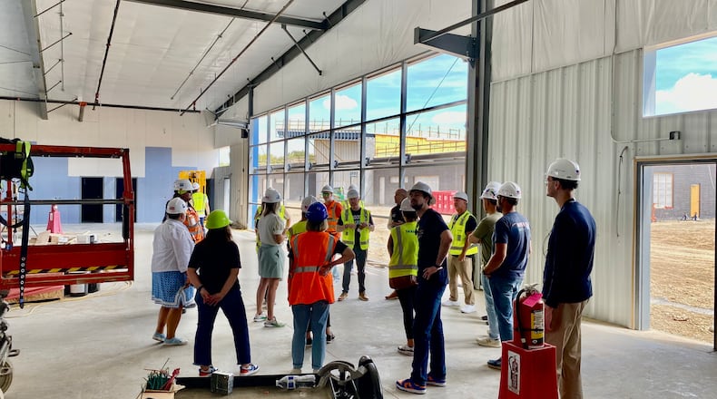 Butler Tech’s $15 million Aviation Hangar is rising from construction dust next to the city’s air strip and teachers and administrators in the fast-growing program recently got their first tour of the state-of-the-art school’s construction site. (Photo By Michael D. Clark/Journal-News)