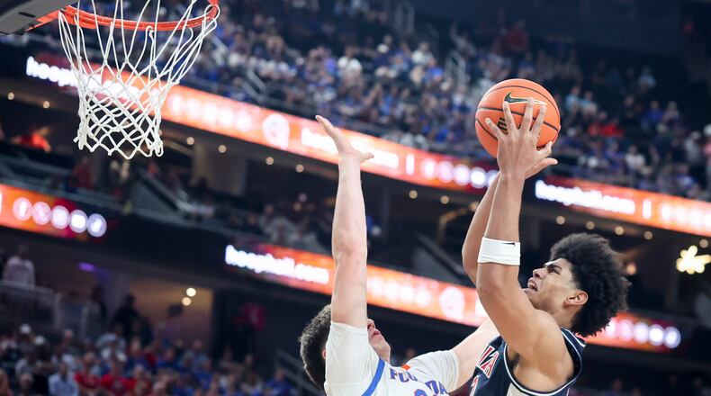Arizona forward Koa Peat (10) shoots against Florida forward Alex Condon (21) during the second half of an NCAA college basketball game, Monday, Nov. 3, 2025, in Las Vegas. (AP Photo/Ian Maule)