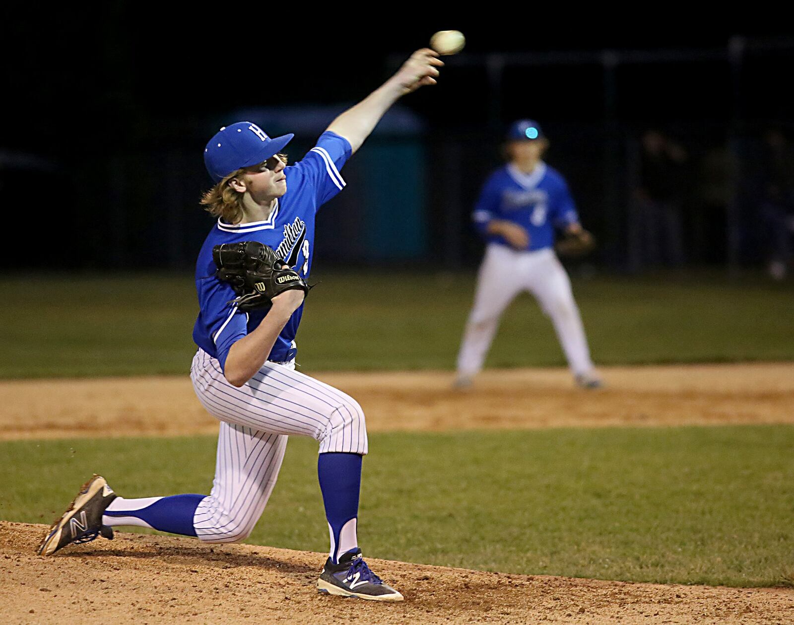 Hamilton pitcher Gunner Kellum throws to a Badin batter during Saturday night’s game at Alumni Field in Hamilton. CONTRIBUTED PHOTO BY E.L. HUBBARD