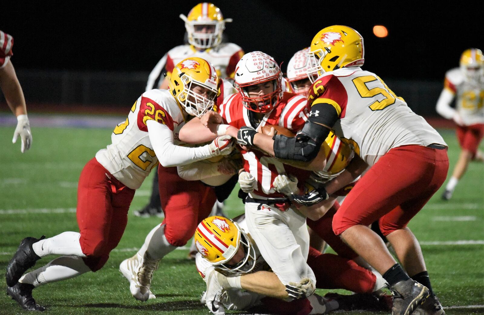 Logan Miller (26) and Sam Secrest (56) are among the Fenwick players in on the tackle of Wapakoneta quarterback Brady Erb (10) on Friday night during a Division III, Region 12 playoff semifinal at Piqua’s Purk Field at Alexander Stadium. CONTRIBUTED PHOTO BY ANGIE MOHRHAUS