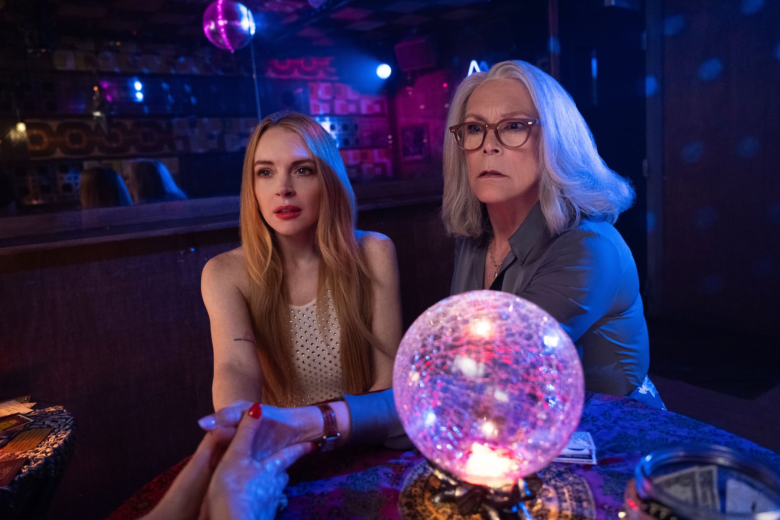 This image released by Disney shows Lindsay Lohan, left, and Jamie Lee Curtis in a scene from "Freakier Friday." (Glen Wilson/Disney via AP)