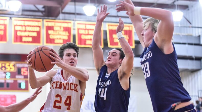 Fenwick’s David Luers drives to the basket against Edgewood’s Garrett Gabbard (44) and Evan Brown (33) during Tuesday night’s game at Fenwick. NICK GRAHAM/STAFF