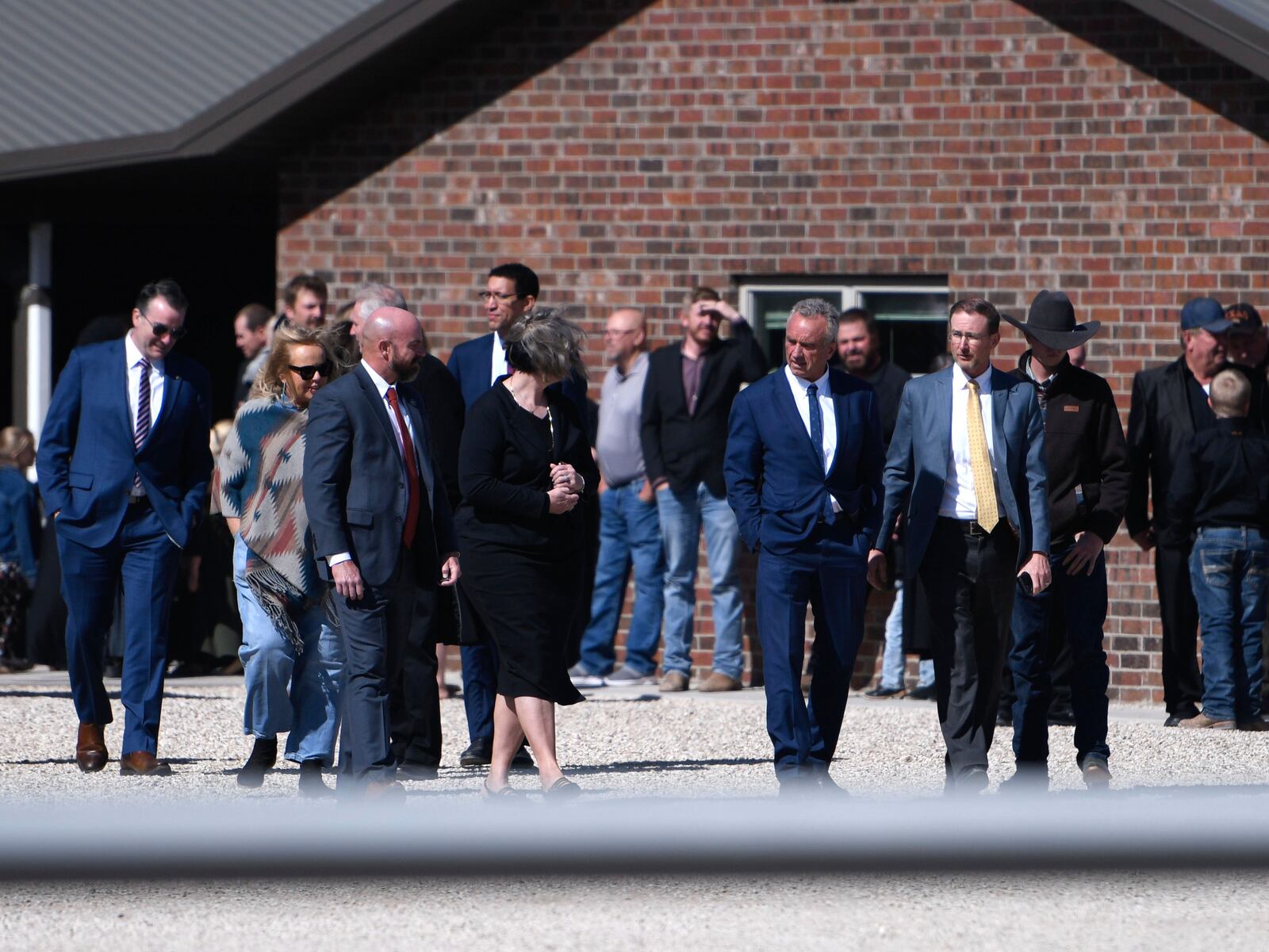 Health and Human Services Secretary Robert F. Kennedy Jr., center right, arrives at Reinlander Mennonite Church after a second measles death, Sunday, April 6, 2025, in Seminole, Texas. (AP Photo/Annie Rice)