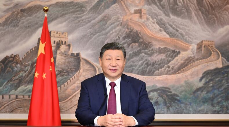 In this photo released by Xinhua News Agency, Chinese President Xi Jinping delivers his 2026 New Year message in Beijing on Wednesday, Dec. 31, 2025. (Yan Yan/Xinhua via AP)