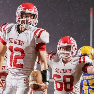 St. Henry senior quarterback Charlie Werling celebrates after a short touchdown run in the third quarter of the Division VII, Region 28 championship game on Friday, Nov. 21 at Mercy Health/Wapak VFW Field in Wapakoneta. Werling scored four TDs to help the Redskins win 24-7 and snap a 76-game winning streak by the Flyers. BRYANT BILLING/STAFF