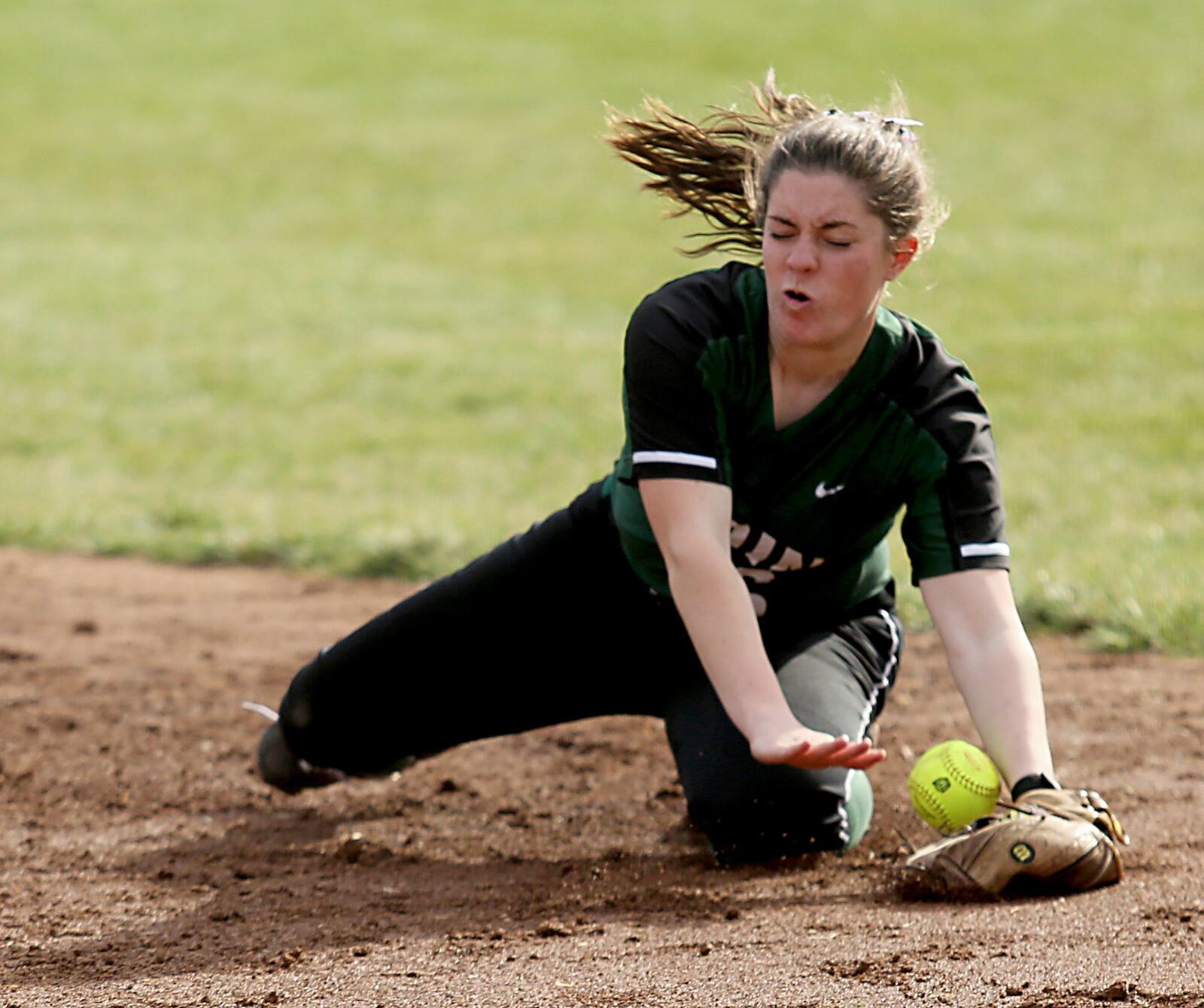 Badin second baseman Josie Link knocks down a Wilmington grounder and makes the throw to first base for the out during Monday’s game at Mueller Stadium in Hamilton. CONTRIBUTED PHOTO BY E.L. HUBBARD