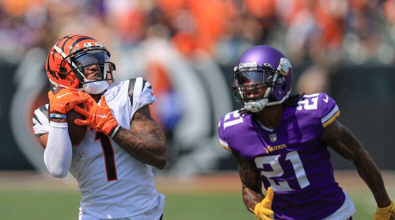 Cincinnati Bengals wide receiver Ja'Marr Chase (1) makes a catch past Minnesota Vikings defensive back Bashaud Breeland (21) and takes it in for a touchdown in the first half of an NFL football game, Sunday, Sept. 12, 2021, in Cincinnati. (AP Photo/Aaron Doster)