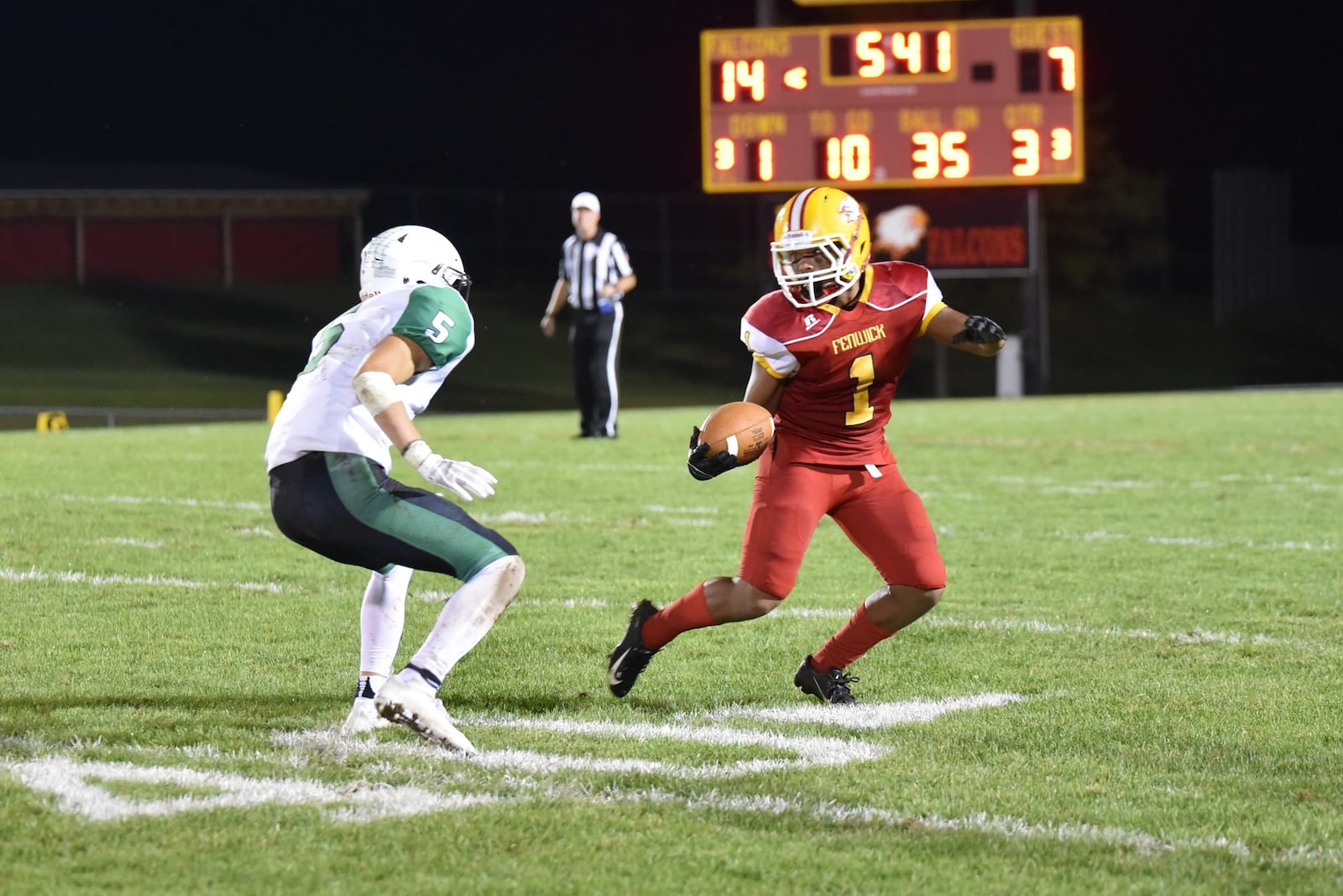 Fenwick’s Jordan Rucker hauls in a pass and looks to get past Badin’s Marshall Flaig on Friday night at Krusling Field in Middletown. The host Falcons won 21-9. CONTRIBUTED PHOTO BY ANGIE MOHRHAUS