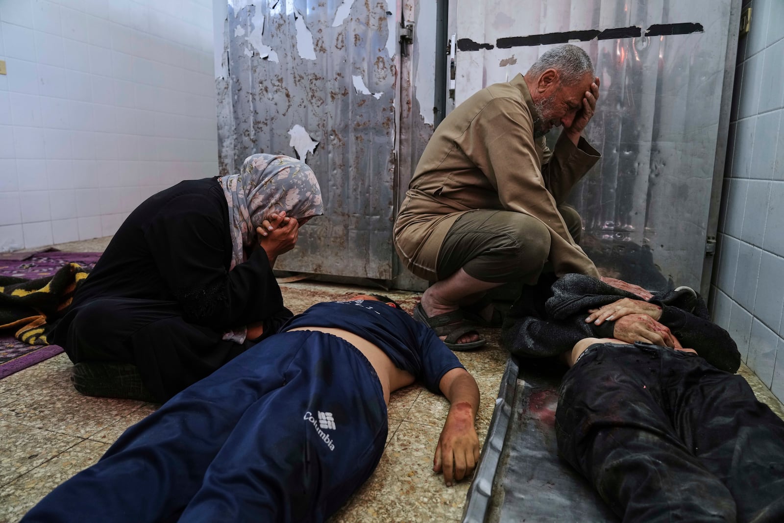 Palestinian mourn their relatives who were killed in an Israeli army airstrike on the Gaza Strip, at the morgue of Al-Aqsa Hospital in Deir al-Balah, Gaza, Sunday, April 27, 2025. (AP Photo/Abdel Kareem Hana)
