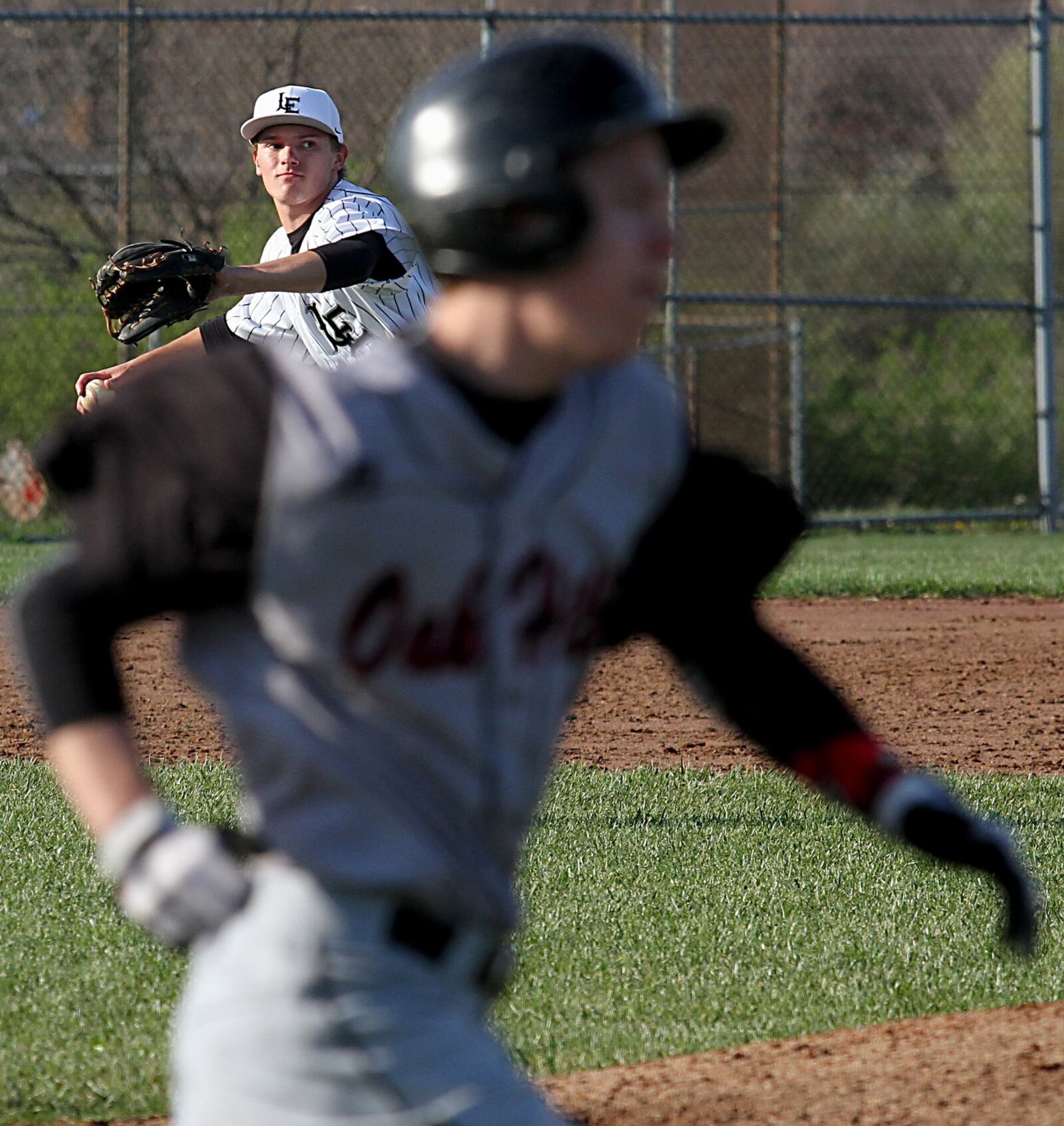 Lakota East third baseman Sam Sprockett prepares to throw to first to get Oak Hills batter Corey Miley on Tuesday at East. CONTRIBUTED PHOTO BY E.L. HUBBARD