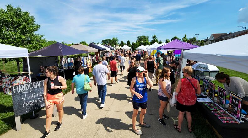 Visitors stroll through Hamilton Flea, a monthly urban artisan market, Saturday, May 14, 2022 at Marcum Park in Hamilton. NICK GRAHAM/STAFF