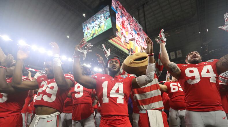 Ohio State players, including K.J. Hill (14) sing “Carmen Ohio” after a victory against Southern California on Friday, Dec. 29, 2017, at AT&T Stadium in Arlington, Texas. David Jablonski/Staff