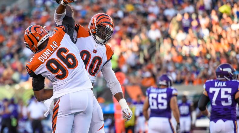 Cincinnati Bengals defensive ends Carlos Dunlap (96) and Michael Johnson (90) celebrate a sack during their first pre-season game against the Minnesota Vikings Friday, Aug. 12 at Paul Brown Stadium in Cincinnati. The Vikings won 17-16. NICK GRAHAM/STAFF