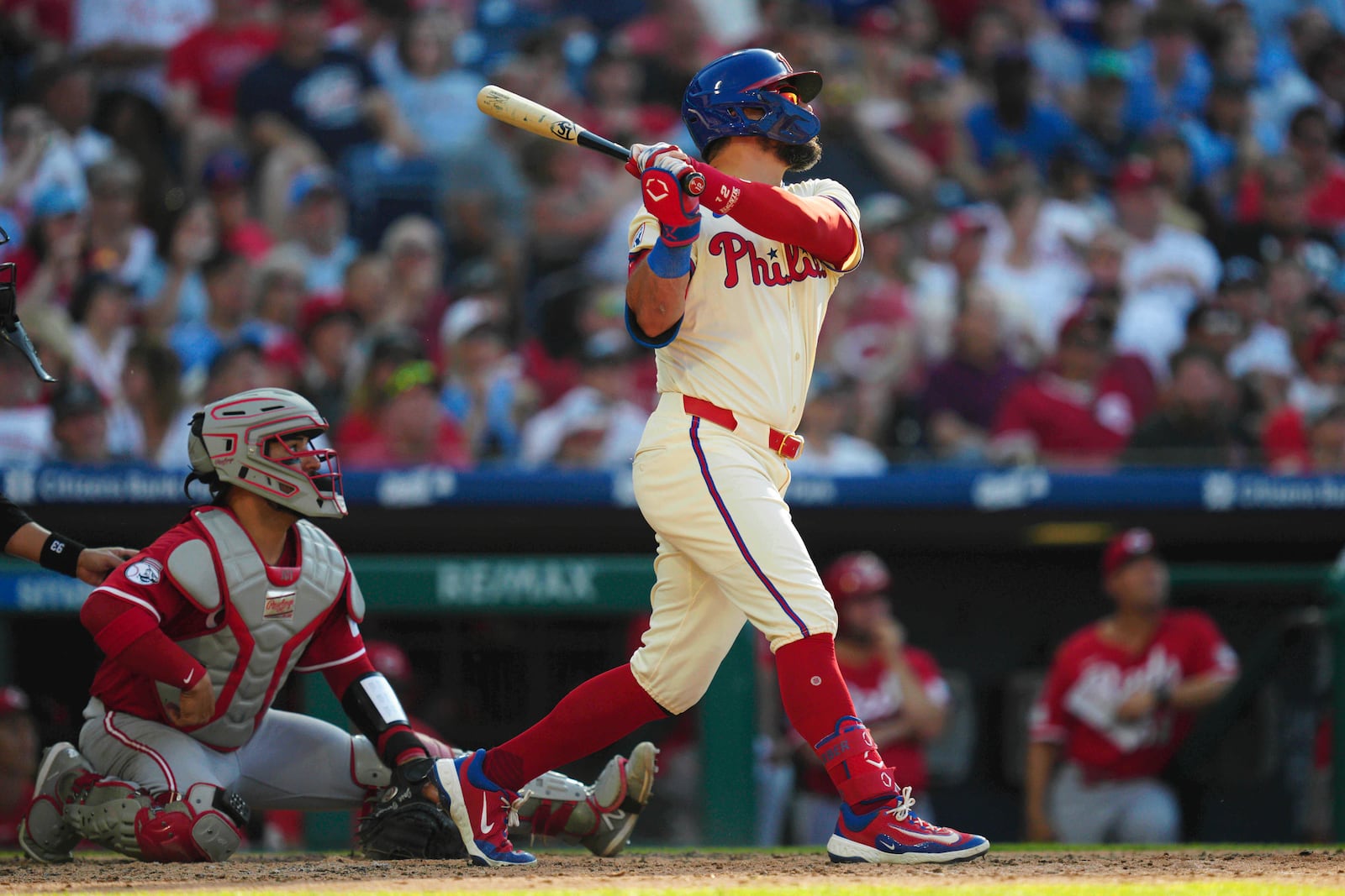 Philadelphia Phillies' Kyle Schwarber, right, watches his two-run home run off Cincinnati Reds pitcher Brent Suter during the eighth inning of a baseball game, Saturday, July 5, 2025, in Philadelphia. (AP Photo/Derik Hamilton)